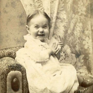 scrunchy faced smiling baby from 1900